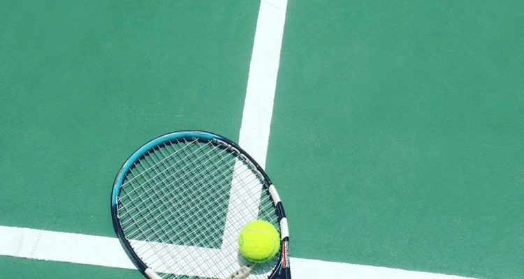 tennis racket and ball on field